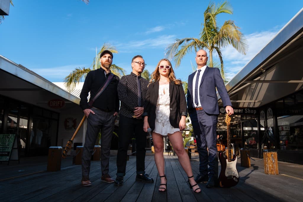 Midnight Fizz — band on a coastal boardwalk with palm trees